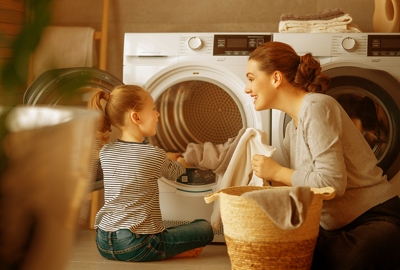 mother and daughter doing laundry mother and daughter doing laundry